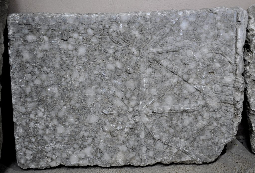 A fragment of a wall relief from the North-West Palace of Ashurnasirpal II at Nimrud. The "Standard Inscription" of Ashurnasirpal II runs over part of a sacred tree or tree of life. Not on display. Exclusive photo; never-before-published. The Sulaymaniyah Museum, Iraqi Kurdistan. Photo © Osama S. M. Amin. 